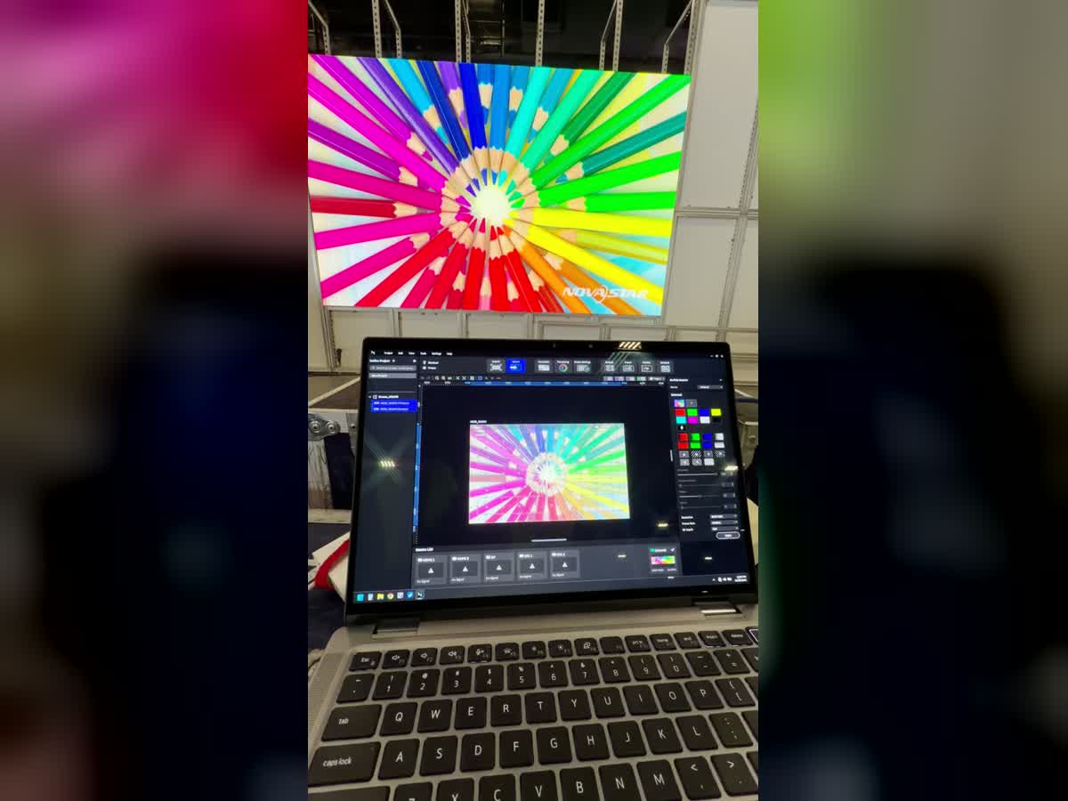 Programming laptop and LED wall showing the same colorful test image at Workday Rising 2026